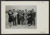 [recto] A family group picture of the Sakura family. Left to right are, Mr. and Mrs. Howard Sakura and their baby, ...