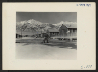 [recto] Manzanar, Calif.--Fire equipment is used to keep the dust down at this War Relocation Authority center. ;  Photographer: Lange, Dorothea ;  Manzanar, California.