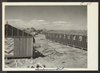 [recto] Construction continues on the War Relocation Authority center for evacuees of Japanese ancestry on the Colorado River Indian Reservation. Three units in the center are scheduled to house 20,000 evacuees eventually. ;  Photographer: Clark, Fred ;  Post