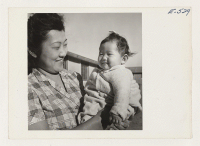 [recto] Mrs. Kobayashi and the youngest of her family. ;  Photographer: Parker, Tom ;  Amache, Colorado.