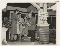 [recto] Takejiro Noguchi, Issei from Gila River, being greeted on arrival at the Pasadena Hostel. Shown left to right are: Miss ...