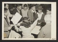 [recto] Byron, Calif.--These field laborers of Japanese ancestry at the W.C.C.A. Control Station are receiving final instructions regarding their evacuation to an Assembly Center in three days. ;  Photographer: Lange, Dorothea ;  Byron, California.