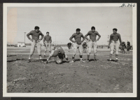 [recto] Warming up for start of football game between Topaz and Fillmore high schools at Topaz Relocation Center, November 11, 1943. ;  Topaz, Utah.
