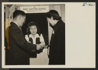 [recto] Fumi Taketa of the Heart Mountain Relocation Office is issuing War Ration Books to Mr. and Mrs. Thomas T. Sashihara, ...