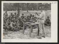 [recto] Lieutenant Watt instructs a class in the mechanism of the Ml rifle. The 442nd combat team at Camp Shelby is ...
