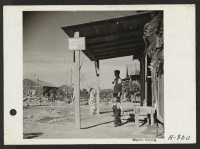 [recto] A scene in block 19, which is ingeniously landscaped by evacuee residents. ;  Photographer: Stewart, Francis ;  Poston, Arizona.