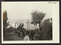 [recto] The fire in block six, Unit I, Poston, which took place November 16. This picture shows firemen and volunteers at work to extinguish the blaze. ;  Poston, Arizona.
