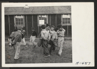 [recto] These boys of the low fifth grade, taught by Mrs. Rhoda McGarva, are playing Cock Fight. ;  Photographer: Stewart, Francis ;  Newell, California.