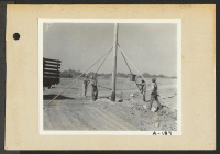 [recto] Poston, Ariz.--(Site #2)--High tension poles being installed at this War Relocation Authority center for evacuees of Japanese ancestry. ;  Photographer: Clark, Fred ;  Poston, Arizona.