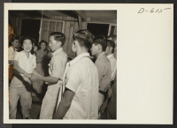 [recto] Evacuees of Japanese ancestry dance the Virginia Reel at a barn dance given by Block 12. No music was available so dancers sang Pop goes the Weasel and clapped hands for rhythm at this War Relocation Authority center where they are spending the duration.