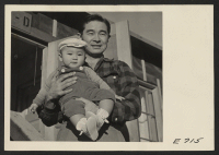 [recto] Paul Nakadati and his son Paul, Jr., better known as Polito. Paul, a young Nisei, was formerly an insurance salesman in Los Angeles. He now teaches Social Sciences in the night school at the Center. ;  Photographer: Parker, Tom ;  Heart Mountain, Wyom
