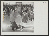 [recto] Laverne Kurahara and Tubbie Kunimatsu demonstrate some intricate jitterbug steps during a school dance held in the high school gymnasium. ;  Photographer: Iwasaki, Hikaru ;  Heart Mountain, Wyoming.