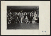 [recto] A demonstration of the theatrical folk lore of old Japan, as presented by players at this relocation center. ;  Photographer: Parker, Tom ;  Heart Mountain, Wyoming.