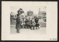 [recto] Salinas, Calif.--Evacuees of Japanese ancestry waiting for the bus which will take them to the Salinas Assembly Center. They will later be transferred to a War Relocation Authority center to spend the duration. ;  Photographer: Albers, Clem ;  Salinas