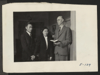 [recto] Reverend Clyde Keegan performs a wedding ceremony at his home in Cody, Wyoming, for Kenichi Tanaka and Miss Shizuko, the first couple to be married at this relocation center. ;  Photographer: Parker, Tom ;  Cody, Wyoming.