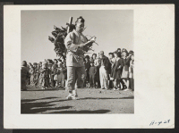 [recto] Great originality in costumes was shown at the Harvest Festival parade held at this relocation center. ;  Photographer: Stewart, Francis ;  Newell, California.