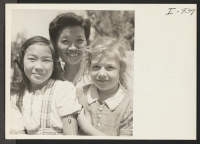 [recto] Mrs. Charles Iwasaki holding her daughter, Amy, and a neighbor girl, Annie Torosian, on her lap. Mrs. Iwasaki is known ...