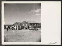 [recto] Tule Lake, Newell, Calif.--This group of evacuees have just arrived at this War Relocation Authority center and are being assigned quarters and bedding. ;  Newell, California.
