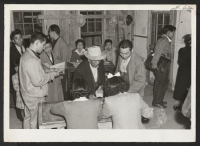 [recto] Arrivals from Tule Lake receiving housing accommodations.--INCOMING ;  Photographer: Aoyama, Bud ;  Heart Mountain, Wyoming.