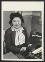 [recto] Toshiko Ryozaki, formerly of Los Angeles, California, and the Granada Center, types from the dictaphone in the office of the ...