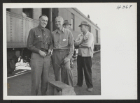 [recto] Raymond R. Best (left), Director of the Tule Lake Relocation Center, and Mortimer C. Cooke, Supply Officer. Cooke was in charge of loading and unloading of trains at the center. ;  Photographer: Mace, Charles E. ; , .