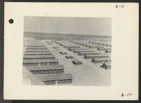 [recto] Poston, Ariz., (Site No. 2)--Living quarters of evacuees of Japanese ancestry at this War Relocation Authority center as seen from water tower. ;  Photographer: Clark, Fred ;  Poston, Arizona.
