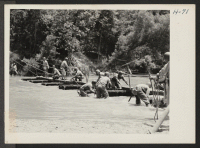 [recto] Building a Pontoon Bridge. Another section is added and the bridge is nearly midway in the stream. This unit, under ...