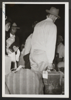 [recto] Segregants boarding on train, 6:30 a.m., Casa Grande--first contingent. ;  Rivers, Arizona.