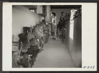 [recto] Shoe repair shop at Camp No. 1. The shoes on the left were received on a single day at this repair shop. ;  Photographer: Stewart, Francis ;  Poston, Arizona.