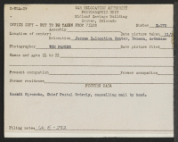 [verso] Masaki Hironoka, Chief Postal Orderly, cancelling mail by hand. ;  Photographer: Parker, Tom ;  Denson, Arkansas.