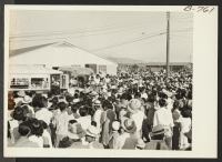 [recto] Large crowd assembled to bid bon voyage to residents of Poston who left the project by bus and truck August 24, 1943, for the Rivers center, on the first lap of the journey to Japan via Gripsholm, which sailed from an eastern seaport Sept. 1. ;  Photogr