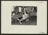 [recto] Manzanar, Calif.--Making artificial flowers in the Art School at this War Relocation Authority center for evacuees of Japanese ancestry. ;  Photographer: Lange, Dorothea ;  Manzanar, California.