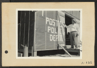 [recto] Poston, Ariz.--Police Chief Kiyoshi Shigekawa painting sign on first police station at this War Relocation Authority center for evacuees of Japanese ancestry. ;  Photographer: Clark, Fred ;  Poston, Arizona.
