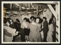 [recto] Nisei soldiers and civilians at a U.S.O. dance in Terry Hall. ;  Amache, Colorado.