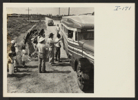 [recto] Closing of the Jerome Center, Denson, Arkansas. Transportation officials finish checking a bus load of Jerome residents as they depart for the Rohwer Center. ;  Photographer: Iwasaki, Hikaru ;  Denson, Arkansas.