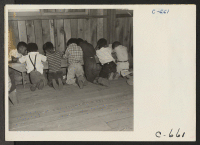 [recto] Manzanar, Calif.--Third grade students working on their arithmetic lesson at this first volunteer elementary school. School equipment was not yet available at the time this photograph was taken. ;  Photographer: Lange, Dorothea ;  Manzanar, California