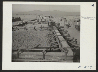 [recto] School buildings. These school buildings are being erected by evacuee laborers. The structures will be of adobe which is made in the local evacuee operated adobe factory. ;  Photographer: Stewart, Francis ;  Poston, Arizona.