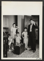 [recto] Mr. and Mrs. Oshima and their three small children, all recently arrived from the Manzanar Relocation Center, survey their new ...