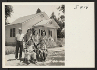 [recto] Mr. and Mrs. Tonokichi Doi are shown with their children, Noboru, Minoru, Eleanor, and Betty in the yard of their ...
