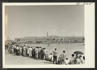 [recto] Part of the crowd of 2,000 people, evacuees and outsiders, who witnessed a baseball game Sunday, September 12, 1943, between the Prowers County all-star team and an Amache team. The Amache team won, 20-9. ;  Photographer: McClelland, Joe ;  Amache, Co
