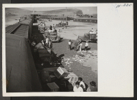 [recto] A scene at the Tule Lake freight yards, where heavy baggage belonging to the new arrivals is being transported from the baggage cars to the warehouse. Needless to say, many tons of baggage leave and arrive with each segregation train. ;  Photographer: M