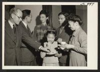 [recto] Enjoying refreshments at the housewarming party at the new Manhattan Hostel for Japanese Americans on November 23, 1945, are Robert ...