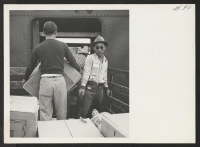 [recto] OUTGOING--Unloading freight. ;  Photographer: Aoyama, Bud ;  Heart Mountain, Wyoming.