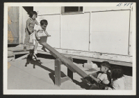[recto] Kindergarten and nursery children having a grand time on the see-saw. ;  Rivers, Arizona.