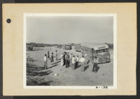 [recto] Poston, Ariz.--The bus in the foreground is stuck in the sand while on its way to the Colorado River War Relocation Authority center bringing evacuees of Japanese ancestry. ;  Photographer: Clark, Fred ;  Poston, Arizona.