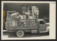 [recto] Closing of the Jerome Center, Denson, Arkansas. Freight belonging to Jerome residents was loaded a day or two in advance of the departure of the evacuees. The crews doing this heavy work were augmented by Caucasians recruited from outside the center. ;