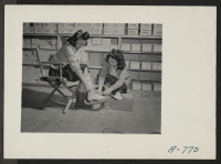 [recto] Selling slates in community store in Block 30. (L to R) Betty Yasunobu, Nellie Arai, salesgirl. ;  Photographer: Stewart, Francis ;  Hunt, Idaho.