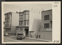 [recto] The moving van backs up to the curb to load possessions of residents of Japanese ancestry who are being evacuated from this flat building on Post Street. Evacuees will be housed in War Relocation Authority centers for duration. ;  Photographer: Lange, D
