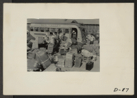 [recto] Eden, Idaho--Baggage, belonging to evacuees who have just arrived from the assembly center at Puyallup, Washington, is sorted and trucked to owners in their barrack apartments. ;  Photographer: Stewart, Francis ;  Hunt, Idaho.