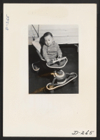 [recto] This picture of an evacuee child was taken for evacuee use. This picture is interesting from a documentary angle, however, for it shows the doll-like features of the Japanese children. ;  Photographer: Stewart, Francis ;  Newell, California.